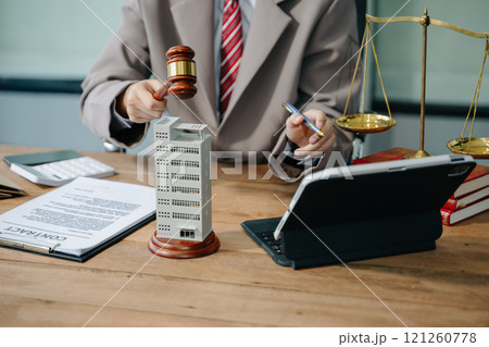 Real Estate Lawyer And House Foreclosure Law. House model, hammer judge gavel on table with white background. Foreclosure, bankruptcy concept 121260778