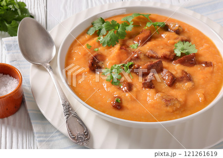 creamy carrot beef soup in a white bowl creamy carrot beef soup in a white bowl 121261619