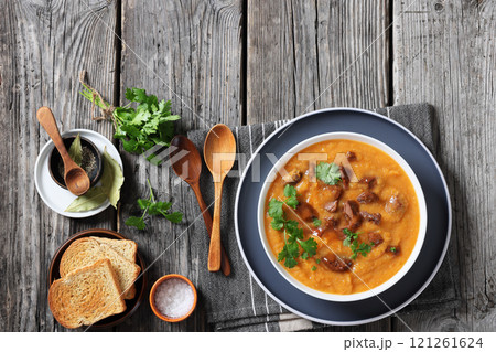 creamy carrot beef soup in a white bowl creamy carrot beef soup in a white bowl 121261624