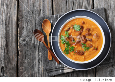 creamy carrot beef soup in a white bowl creamy carrot beef soup in a white bowl 121261626