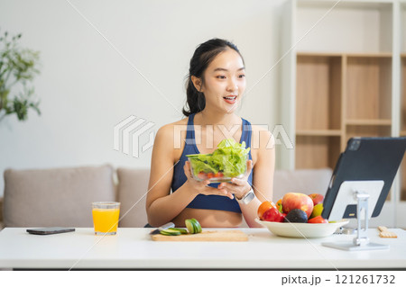 Fit woman enjoys healthy fruit breakfast, healthy lifestyle. 121261732