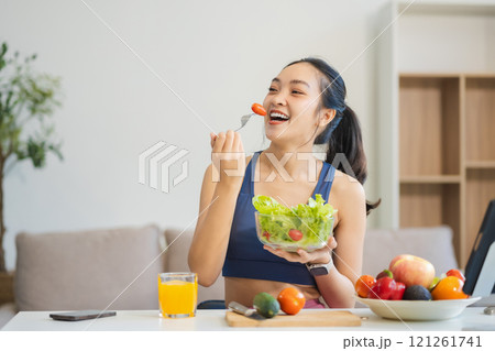 Fit woman enjoys healthy fruit breakfast, healthy lifestyle. 121261741