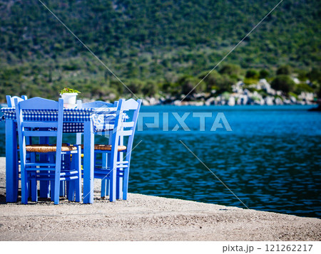 Open cafe outdoor restaurant in Greece on sea shore 121262217