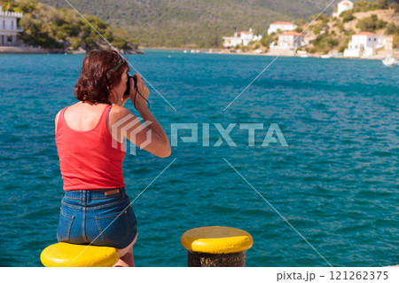 Tourist take photo in greek marina 121262375