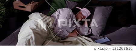 Website banner with woman sleeping in comfortable bed, purple smartphone next to her Website banner with woman sleeping in comfortable bed, purple smartphone next to her 121262610