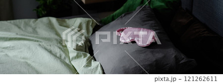 Website banner with silk pink rose sleep mask on grey pillow Website banner with silk pink rose sleep mask on grey pillow 121262611