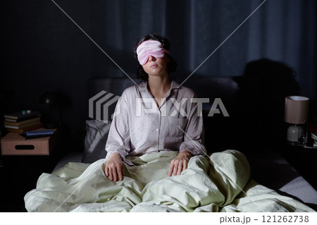 Sleepy woman sitting in bed during night, she suffering from sleepwalking Sleepy woman sitting in bed during night, she suffering from sleepwalking 121262738
