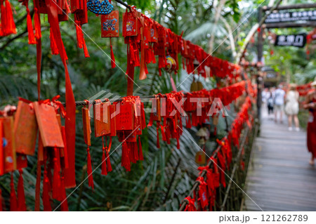 Chinese Red Prayer Tags are Beautifully Hanging in Nature Among the Trees and Greenery 121262789
