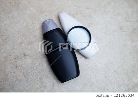 Female hands holding a can of shampoo with a blank label. White background, space for text. Composition of shampoo or conditioner Female hands holding a can of shampoo with a blank label. White background, space for text. Composition of shampoo or conditioner 121263034