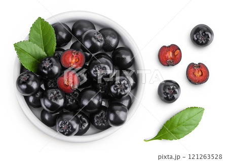 Chokeberry with leaf in a ceramic bowl isolated on white background. Black aronia. Top view. Flat lay 121263528