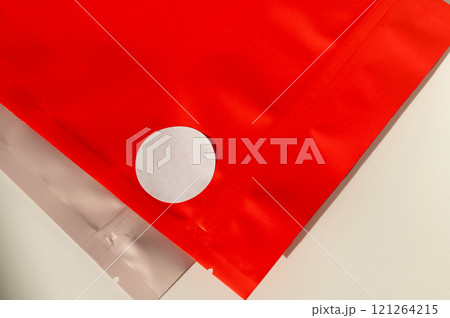 Red packaging bag with white sticker on surface Red packaging bag with white sticker on surface 121264215