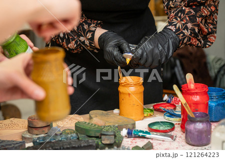 Artistic workshop with female hands creating colorful craft prints 121264223