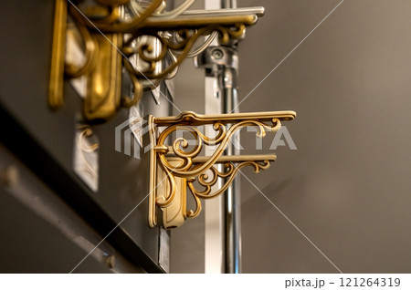 Decorative metal shelf brackets in various styles on display. 121264319