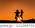 Silhouette of a girl and a man on a motorcycle.  121264734