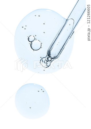 Pipette and drops of cosmetic serum for the skin. Liquid body care product. Isolated on a white background. 121266605