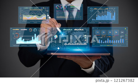 Businessman analyzing financial data on tablet with futuristic digital dashboard and visual analytics 121267382