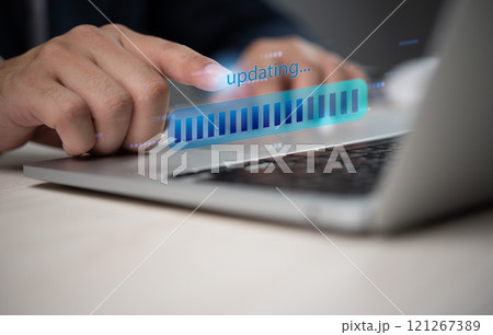 Close up of hand updating software on laptop digital progress bar technology concept Close up of hand updating software on laptop digital progress bar technology concept 121267389
