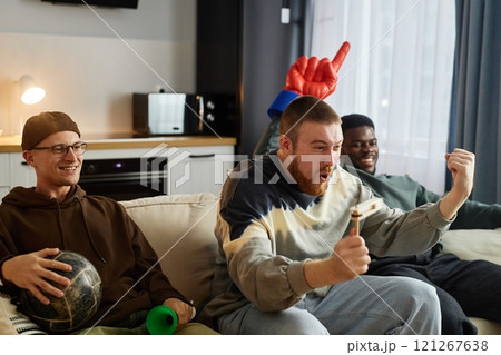 Group of emotional sports fans yelling in excitement while watching game match on TV at home, copy space 121267638