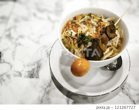 A bowl of Soto Ayam, a popular Indonesian soup 121267727