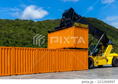 Reach stacker cargo forklift container box import export logistic transportation industrial, Reach stacker pick up container, Reach stacker container loader crane lifting maritime cargo container. 121268997