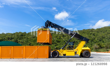 Reach stacker cargo forklift container box import export logistic transportation industrial, Reach stacker pick up container, Reach stacker container loader crane lifting maritime cargo container. 121268998