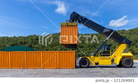 Reach stacker cargo forklift container box import export logistic transportation industrial, Reach stacker pick up container, Reach stacker container loader crane lifting maritime cargo container. 121269001