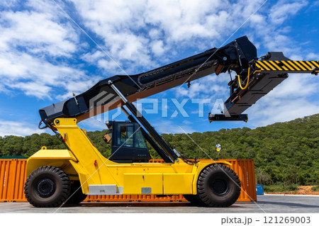 Reach stacker cargo forklift container box import export logistic transportation industrial, Reach stacker pick up container, Reach stacker container loader crane lifting maritime cargo container. 121269003