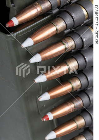 .50 BMG caliber machine gun ammunition belt with cartridges in ammunition can. 121269833