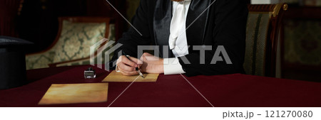 Header image of young gentleman writing letters with ink while sitting at table in classic interior lit by soft natural light, copy space Header image of young gentleman writing letters with ink while sitting at table in classic interior lit by soft natural light, copy space 121270080