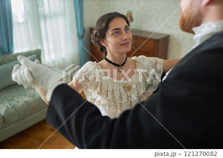 High angle portrait of smiling young lady enjoying waltz with gentleman during romantic visit, copy space High angle portrait of smiling young lady enjoying waltz with gentleman during romantic visit, copy space 121270082