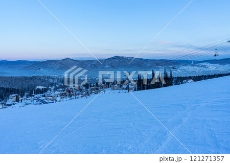 evening at the ski resort, empty ski lift and slope 121271357