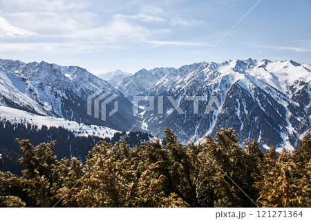 Vew from top of slope on snow capped mountains. Karakol ski resort in Kyrgyzstan 121271364