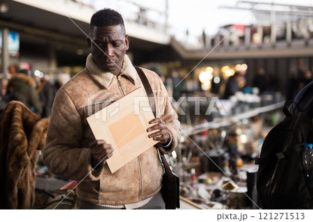 Man chooses antiques at a flea market 121271513