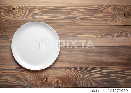empty white plate on wooden table background empty white plate on wooden table background 121271959