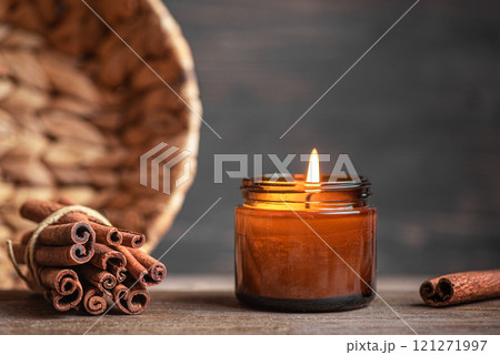 Burning massage candle with cinnamon sticks Burning massage candle with cinnamon sticks 121271997