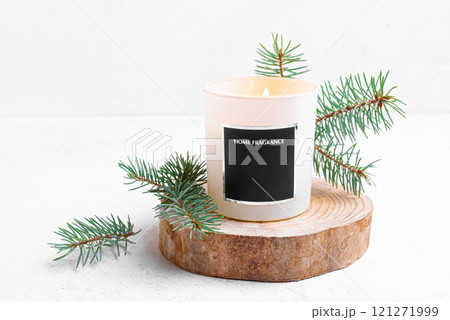 Scented candle in white glass and pine twigs Scented candle in white glass and pine twigs 121271999