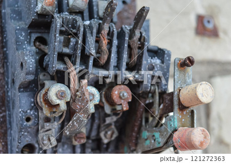 an old broken switch mechanism in which the insides with small wires, bolts and other electrically conductive filling. Old plastic copper and silver contacts. depressing post-apocalyptic View of a 121272363