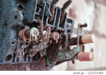 an old broken switch mechanism in which the insides with small wires, bolts and other electrically conductive filling. Old plastic copper and silver contacts. depressing post-apocalyptic View of a 121272364