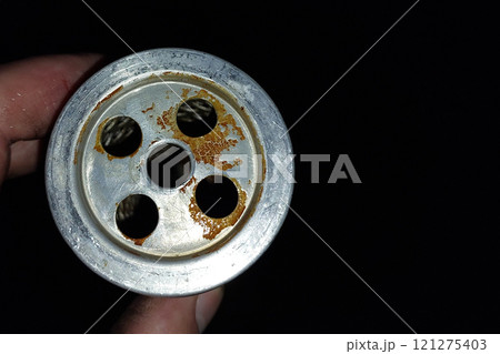 Fuel Filter Mesh Showing Impurities and Rust in a Close-Up View 121275403