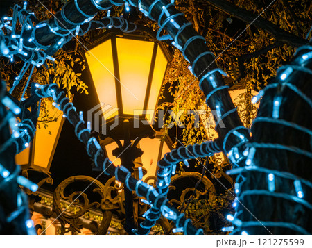yellow urban lantern and blue garlands in night yellow urban lantern and blue garlands in night 121275599