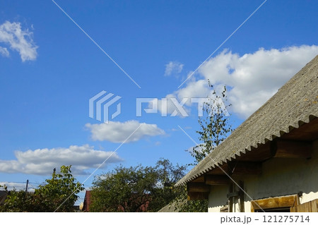 Old Slate Roof of a Charming Village Building Under a Bright Blue Sky Old Slate Roof of a Charming Village Building Under a Bright Blue Sky 121275714