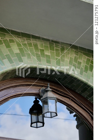 green street lamp on background of semicircular window green street lamp on background of semicircular window 121275791