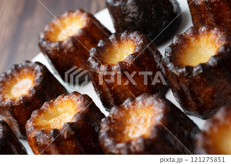 Canneles de bordeaux, traditional French sweet dessert with white table background Canneles de bordeaux, traditional French sweet dessert with white table background 121275851