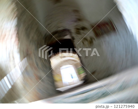 Swirling Abstract Portal Leading to a Luminous Space Within a Mysterious Aged Structure 121275940