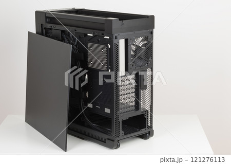 Side view of empty  big tower, PC case, chasis, without upper , left metal panel  and  tempered-glass right  panel. At the bottom is a cover for power supply unit 121276113