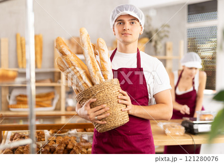 male baker sells croissants, shows off many different crescent-shaped buns male baker sells croissants, shows off many different crescent-shaped buns 121280076
