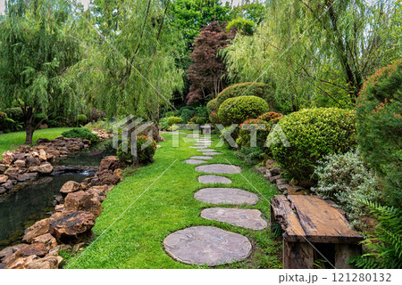 Stone stepping Walkway among lawn in a Japanese style garden. Stone stepping Walkway among lawn in a Japanese style garden. 121280132