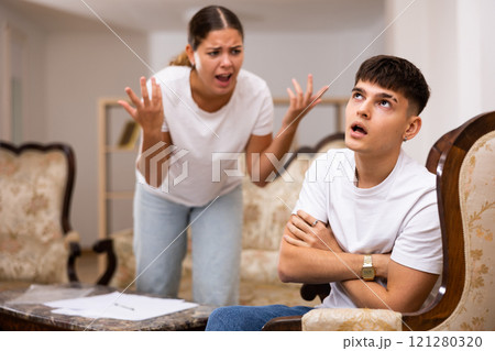 Angry young woman swears at her spouse 121280320