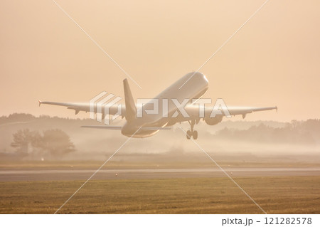 Passenger aircraft take off in morning mist Passenger aircraft take off in morning mist 121282578