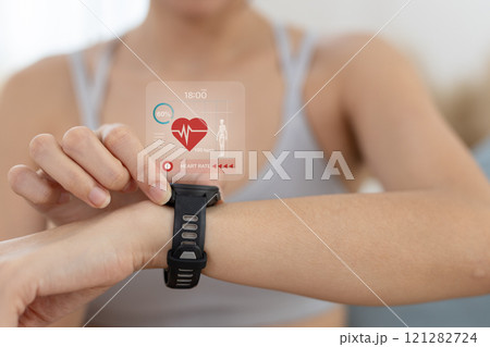 Women Point to smartwatch displaying heart rate application. Monitoring virtual display measure heart rate before after physical exercise. wristwatch checking heart beats and pulse. 121282724